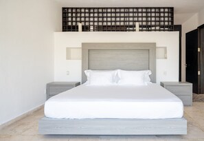A modern bedroom with a large bed, two bedside tables, a wooden headboard, and a black partition above the bed. - 5min walk to beach, housekeeping, pool at terrace, oceanview jacuzzi at rooftop (Playa del Carmen)