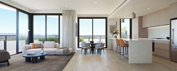 Un apartamento moderno con balcón, comedor, cocina y zona de estar.