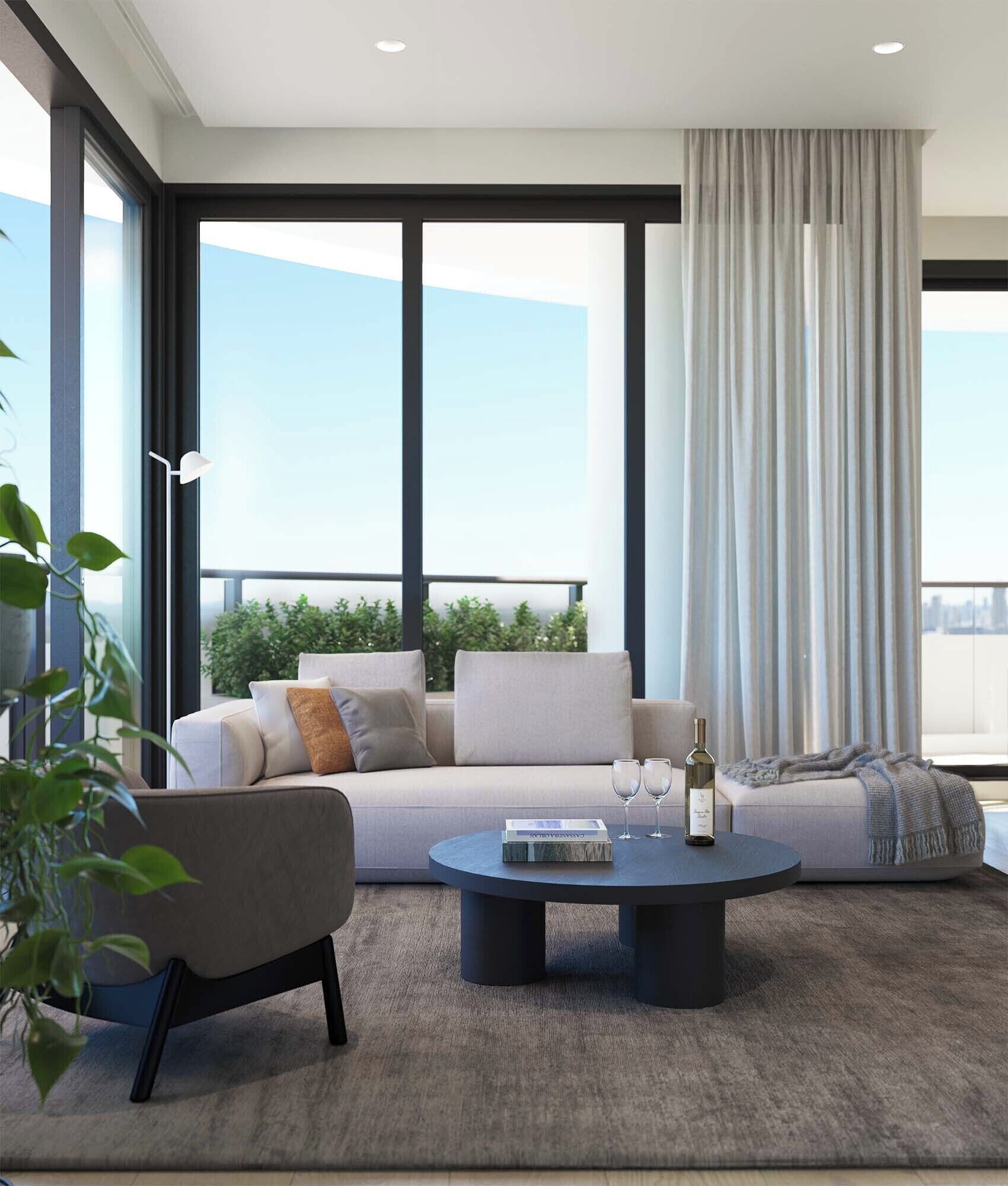 A modern living room with a sofa, coffee table, and a view of the city.