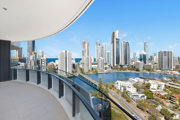 A high-rise building with a view of a city skyline and a body of water. - Chevron One Residences (Surfers Paradise)