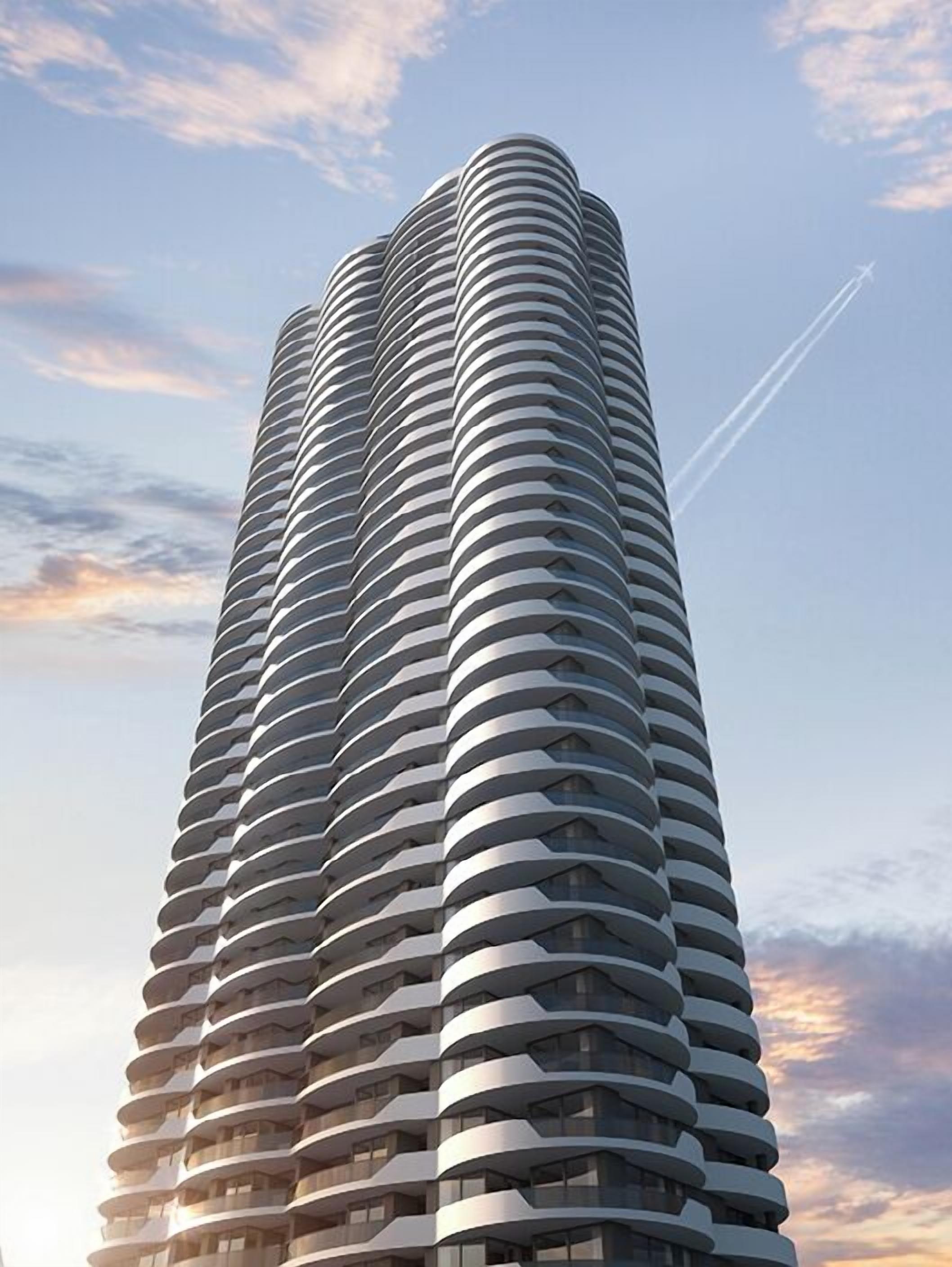 A tall, cylindrical building with a repeating pattern of balconies.
