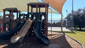 A playground with slides and a shaded area. - Cozy Florida Retreat | Pool | Beach | Comfort (St. Augustine)