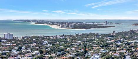 A coastal town with residential buildings, a beach, and a marina.