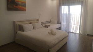 A bedroom with a large bed, a smaller bed, a painting on the wall, and a window with curtains. - Exceptional villa with private pool and 1300m² grounds (Marrakech)