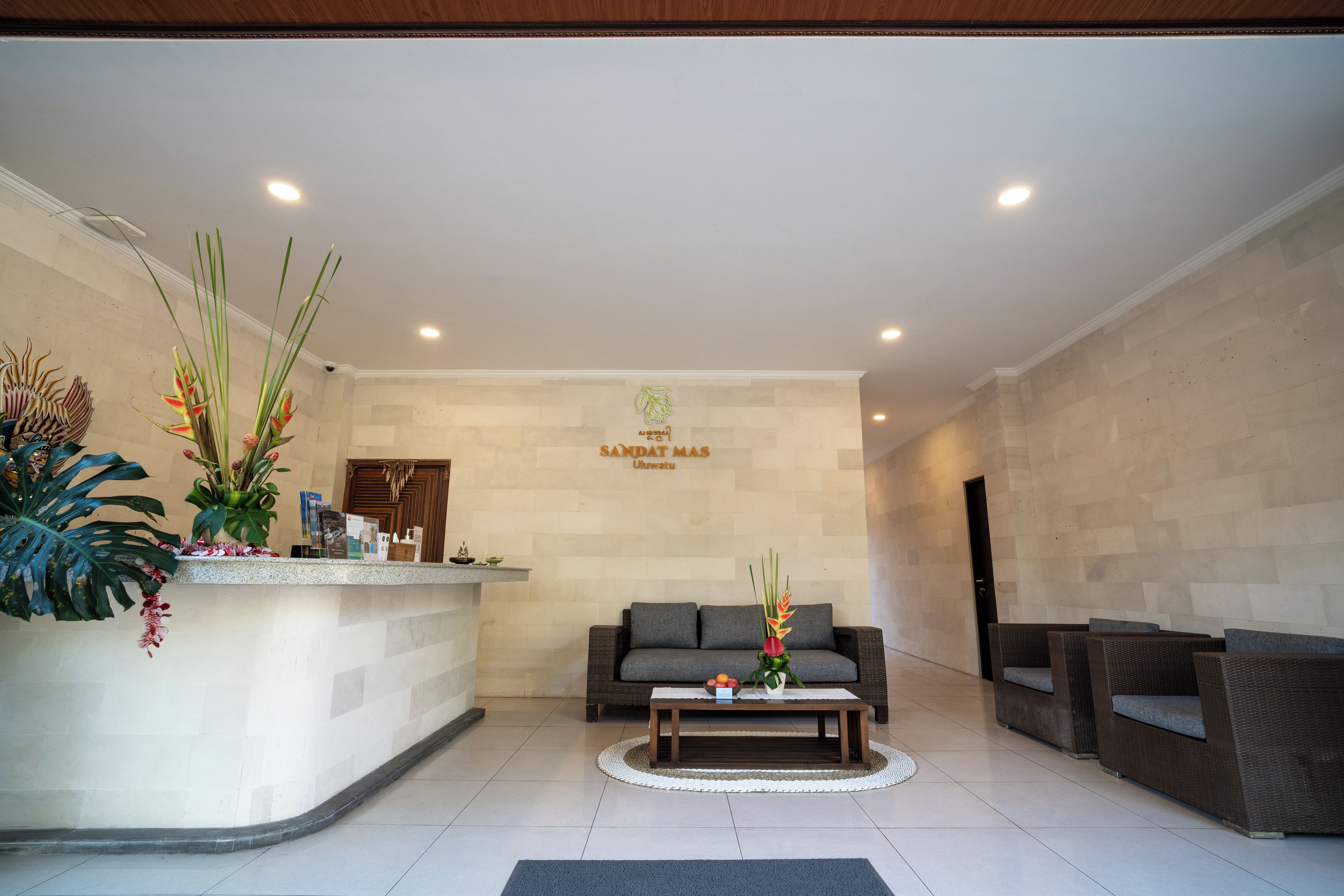 A reception area with a reception desk, a sofa, and a coffee table.