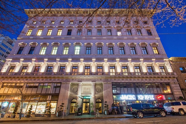 A multi-story building with a classical architectural style, featuring a prominent entrance with a sign that reads 'Valet'.