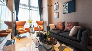 A modern living room with a sofa, armchairs, a coffee table, and artwork on the walls. - Hengbang Times Huaqiang North Store (Shenzhen)
