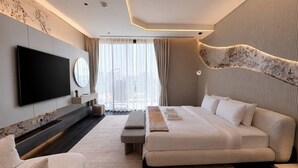 A modern hotel room with a large bed, a flat-screen TV, a seating area, and a view of the city. - 6BR Lamborghini Villa Cinema Spa & Pool (Dubai)