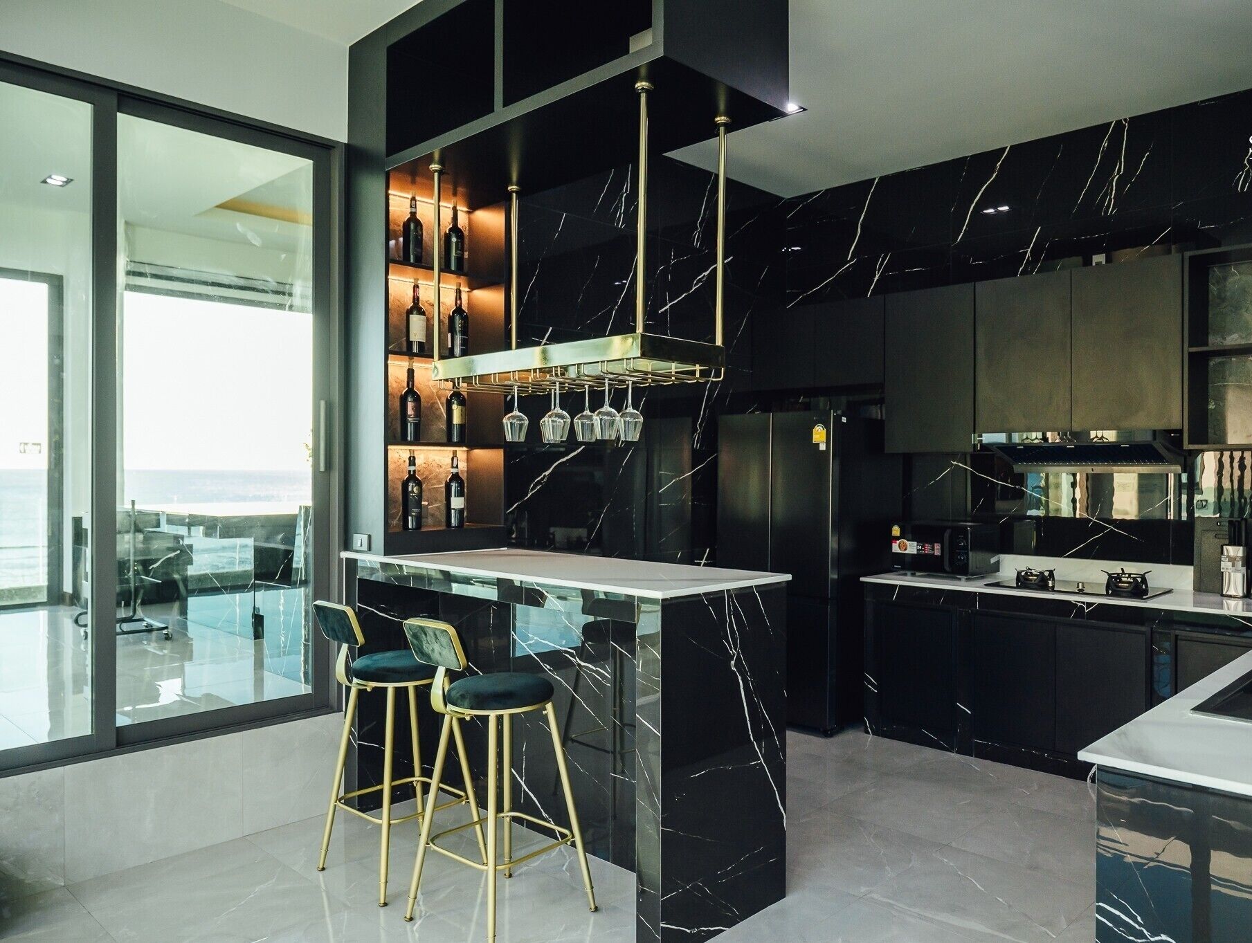 A modern kitchen with a marble backsplash, a wine rack, and bar stools.