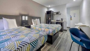 A hotel room with two beds, a desk, a chair, and a kitchenette. - 2 Full Beds|Nsmk|Kitchen (Little Rock AR)