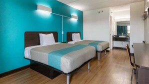A hotel room with two beds, a desk, and a kitchenette. - 2 Queen Beds | Non-Smoking (Macon)