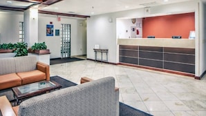 A reception area with a counter, seating, and potted plants. - 2 Queen Beds|Suite,Nsmk, Sofa-Bed (Dallas)