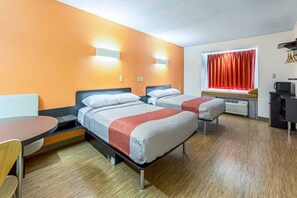 A hotel room with two beds, a dining table, a small kitchenette, and a window with curtains. - 2 Queen Beds | Non-Smoking (Indianapolis IN)