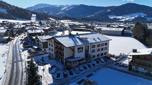 A snow-covered town with a prominent building labeled 'MM DAHOHA.' - Hotel Dahoam by Miha (Westendorf)
