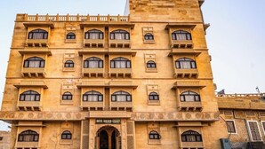 A multi-story building with a traditional architectural style, featuring arched windows and decorative elements. - Hotel Aurang Heritage (Jaisalmer)