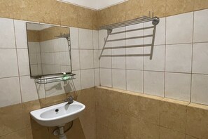 A bathroom with a sink, mirror, and towel rack. - Stylish Delux Stay Near Mall Panakkukang With Wifi (Makassar)