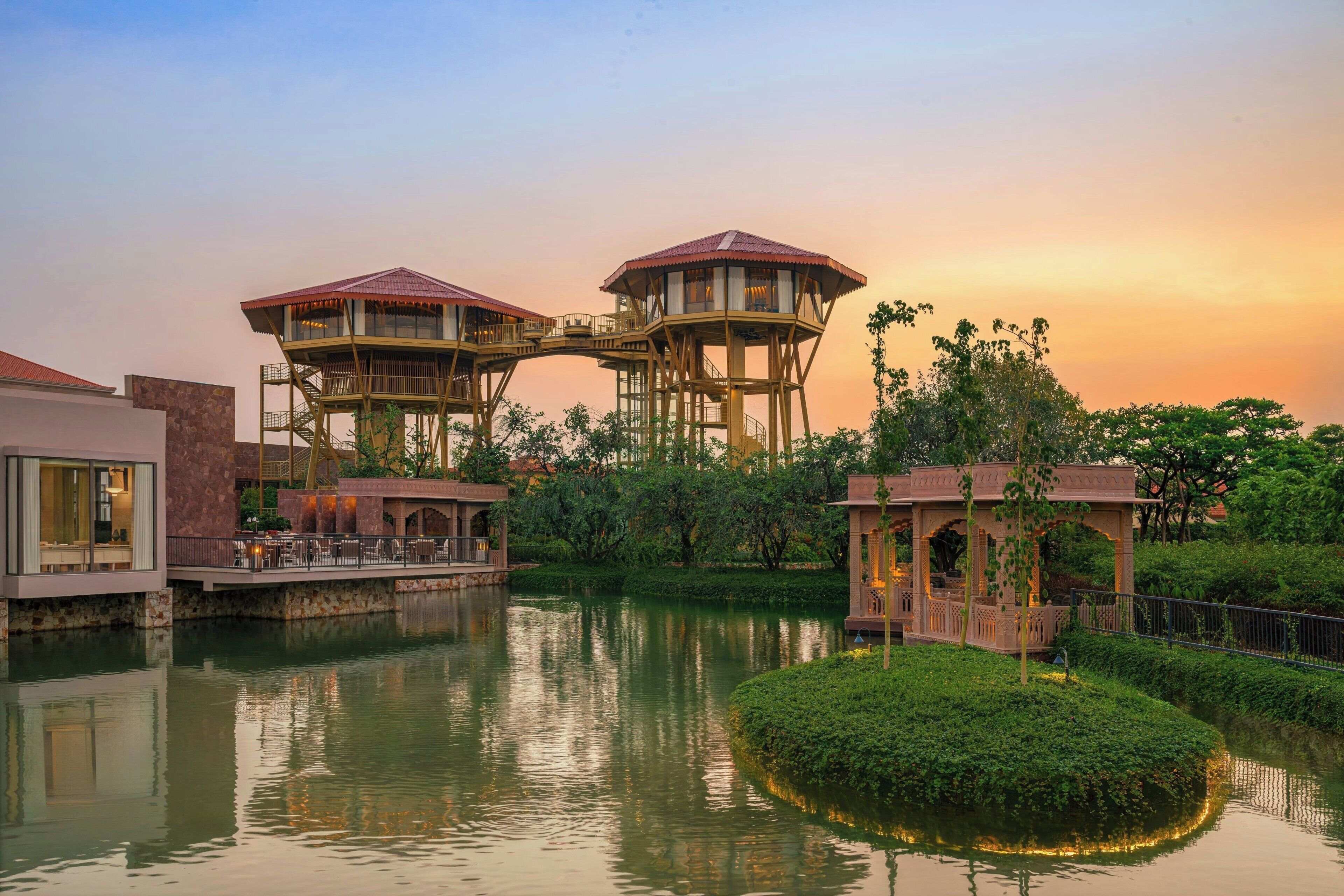 A water body with a bridge connecting two elevated structures with observation decks.