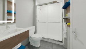 A modern bathroom with a white sink, toilet, and shower. - Microtel Inn & Suites by Wyndham Blytheville (Blytheville)