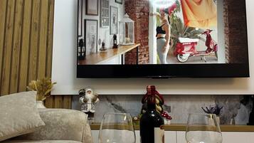 Apartment, 1 Bedroom, Balcony | Living area | 65-inch Smart TV with digital channels, video-game console