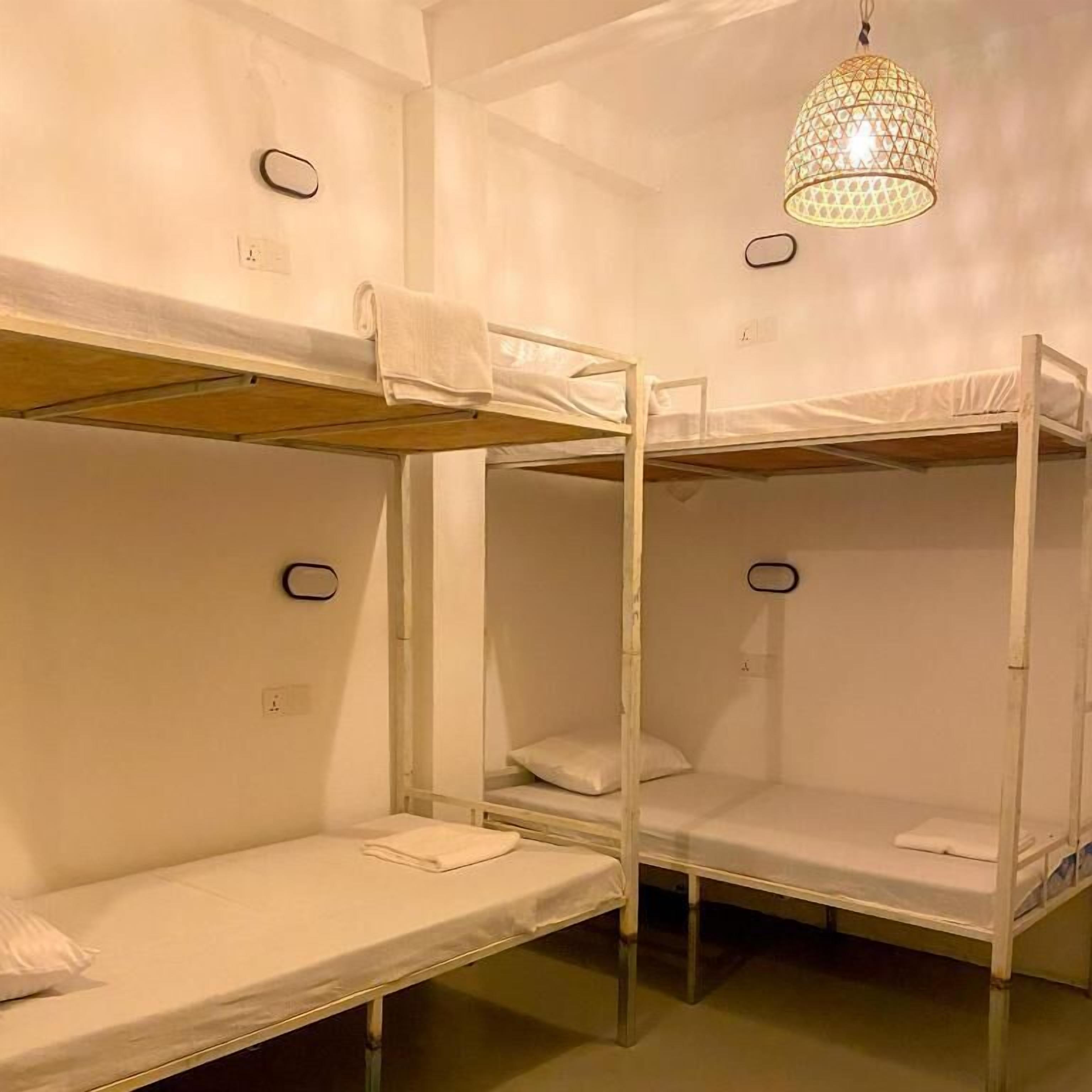 A bunk bed room with a hanging light fixture.