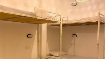 A bunk bed room with a hanging light fixture.