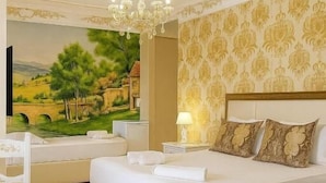 A bedroom with a large bed, a chair, a nightstand, and a wall-mounted TV. - Hotel Antalya Beach Durres (Durrës)