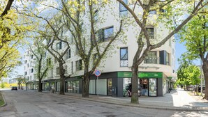 A street view with a row of modern buildings, a no parking sign, and a cafe with outdoor seating. - Żeromskiego 23 by Grand Apartments (Gdynia)
