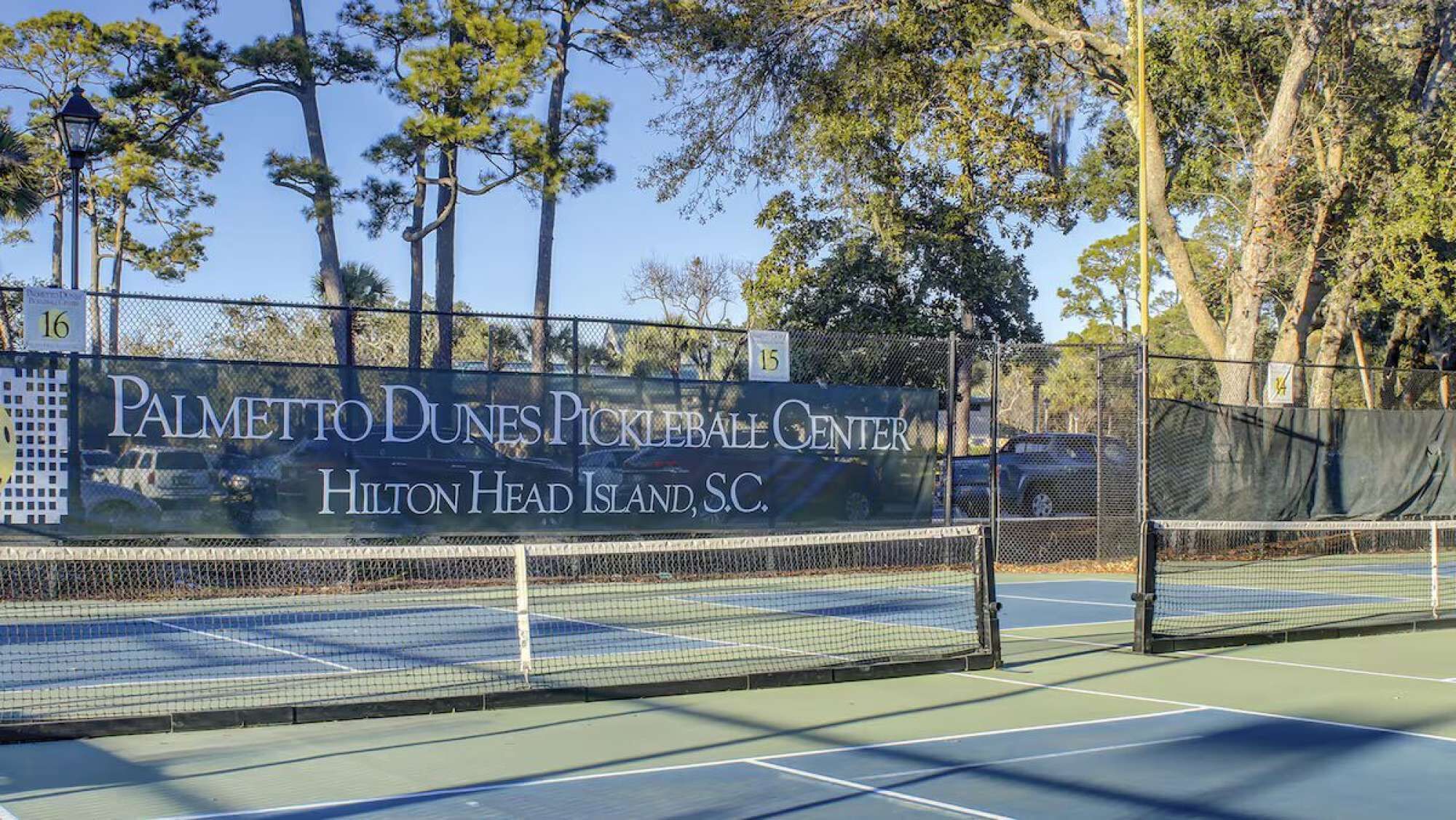 A tennis court with a sign for Palmetto Dunes Pickleball Center in Hilton Head Island, S.C.