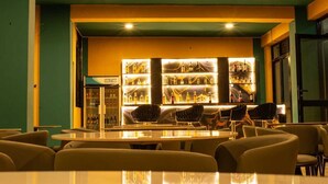 A bar area with a counter and seating, a refrigerated display case, and a sign reading 'SOULSTAR'. - WYNE'S HOTEL STANDARD ROOM (Mbale)