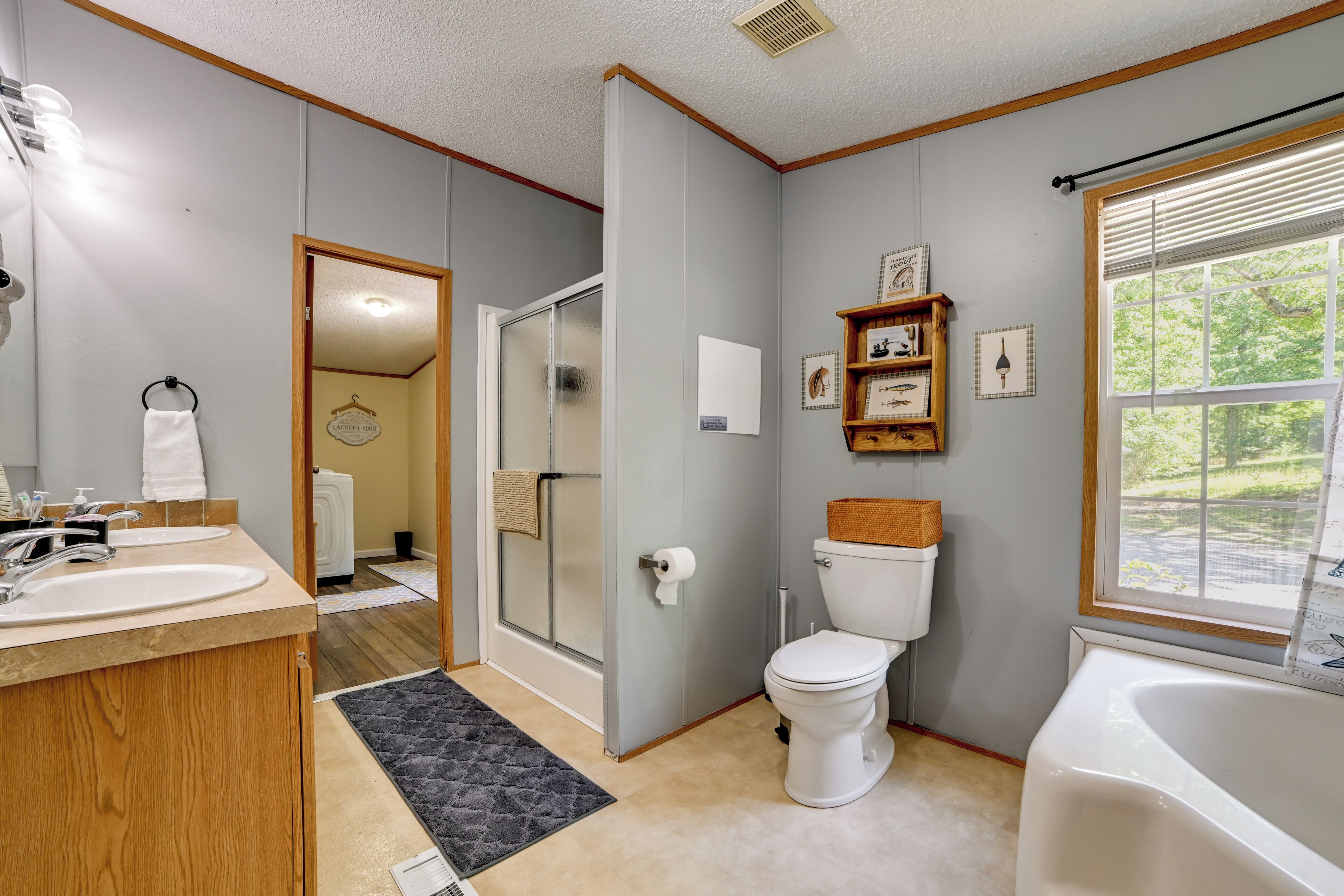 A bathroom with a toilet, sink, shower, and bathtub.