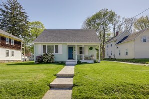 A single-story house with a front porch, a small front yard, and a pathway leading to the door. - < 1 Mi to Dtwn Westerly! Walkable Coastal Escape (Westerly)