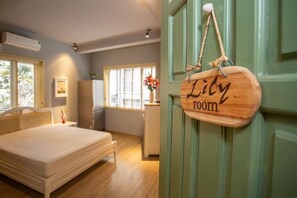 A bedroom with a bed, a small bedside table, a nightstand, a dresser, and a window with curtains. - Chez Van (Ha Noi)