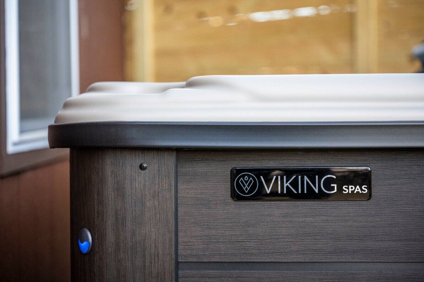 A spa with a wooden exterior and a label reading 'VIKING SPAS.'