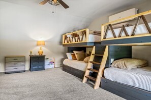 A bedroom with bunk beds, a desk, a chair, and a lamp. - Luxury Lakefront! 5BR*Lake Access*Hot Tub*Private! (Sevierville)