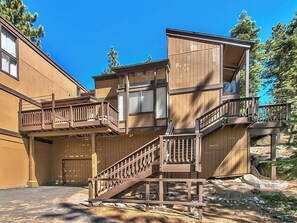 A multi-story building with wooden balconies and staircases.
