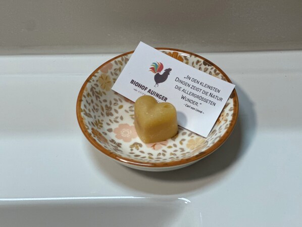 A small plate with a heart-shaped object and a card with text.