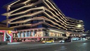 A multi-story hotel with a modern design, featuring a prominent logo at the top. - Benesta Centro by GOLDFINCH (Istanbul)