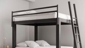 A bunk bed with a ladder, white bedding, and a small wooden stool with a flower. - Beautiful New Home - Min to Airport and Space Museum! (Madison)