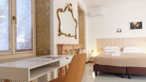 A hotel room with a desk, chair, bed, and a fireplace. - Dimora Giardino di Giulietta (Verona)