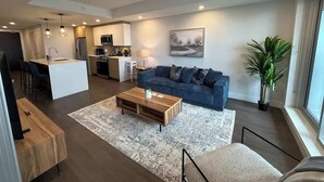 A modern living space with a kitchen, dining area, and a sofa. - Halifax waterfront 2 BR/2 Bath with 6 appliances (Halifax)