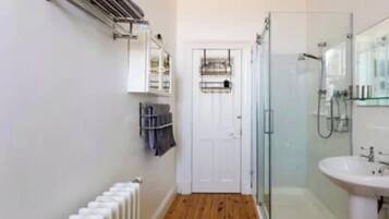 Separate bathtub and shower, deep-soaking bathtub, hair dryer, towels