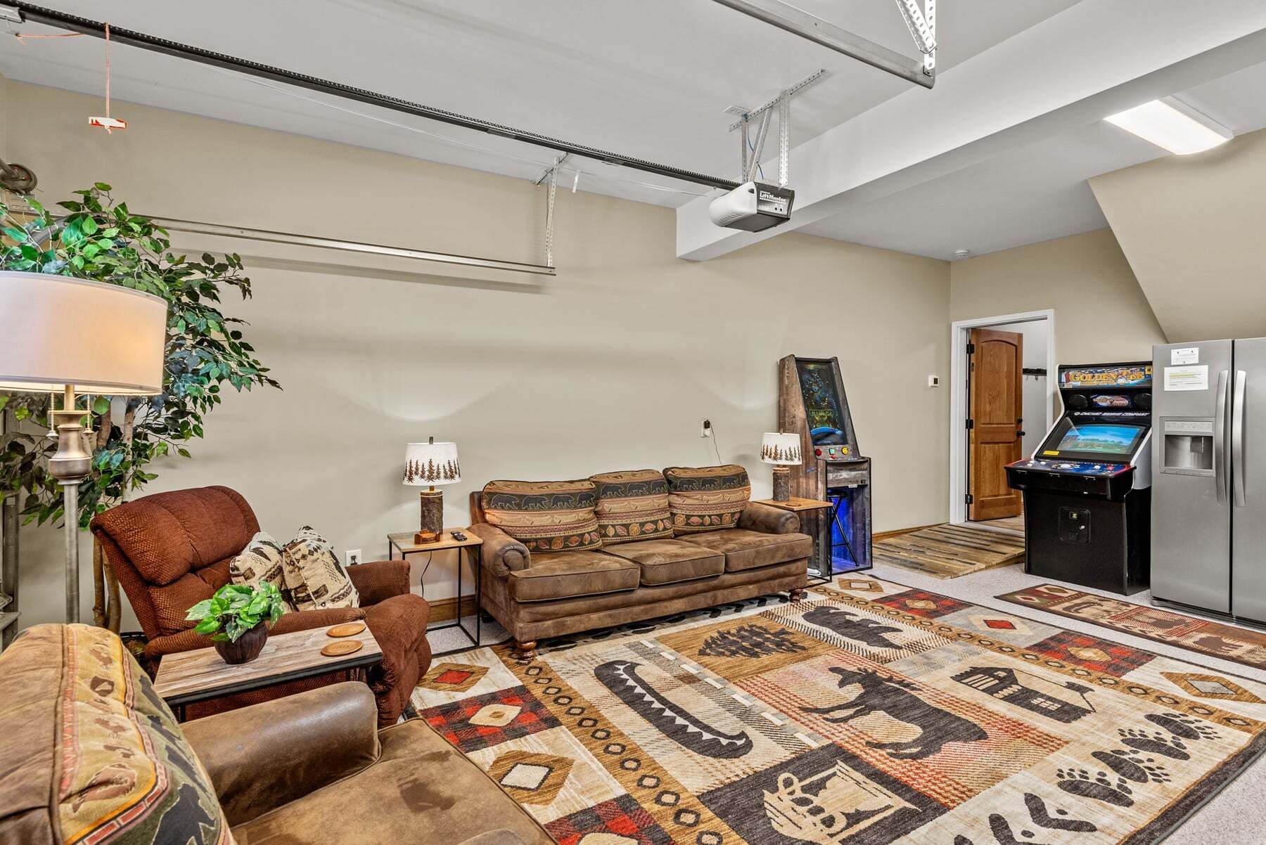 A living room with a sofa, armchair, coffee table, lamp, and a carpet with animal prints.