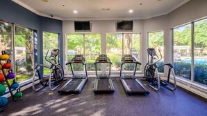 A gym with treadmills, a kettlebell rack, and large windows. - 2713 Kathrynln2 Plano 1BR (Plano)