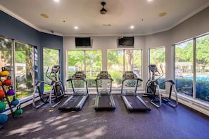 A gym with treadmills, a kettlebell rack, and large windows offering a view of the outdoors. - 2713 Kathrynln2 Plano 1BR (Plano)