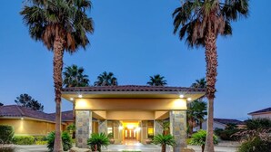 A two-story building with a covered entrance, stone pillars, and a well-maintained lawn. - 591d Theater Room 11 Beds - Spa (Las Vegas)