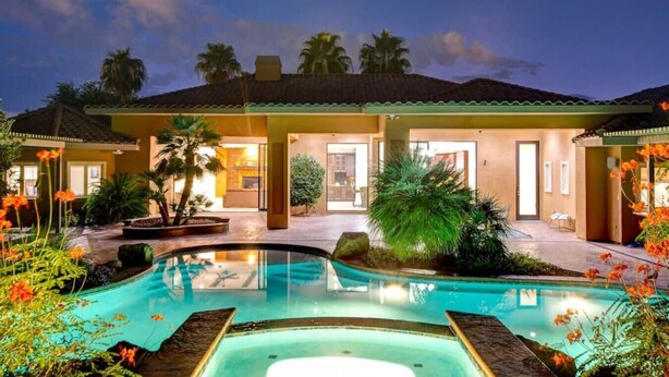 A modern house with a swimming pool, surrounded by tropical plants and flowers. - 591d Theater Room 11 Beds - Spa (Las Vegas)