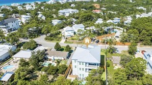 A residential area with houses, a swimming pool, and a large building with a flat roof. - 543 Private Pool Beach Golf Cart 12 Bedroom (Santa Rosa Beach)