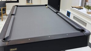 A pool table in a room with a mirror, a door, and a window. - 610e Very Comfortable Studio Downtown (Albany)