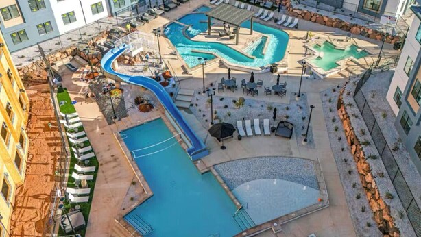 A rooftop pool area with multiple pools, slides, and lounge chairs. - 485 Rooftop Hot Tub - Sleeps 24 (Hurricane)