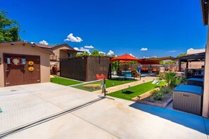 A backyard with a pool, outdoor seating, and a dartboard. - 647 5 Bedrooms Hot Tub Firepit BBQ Kitchen (Glendale)